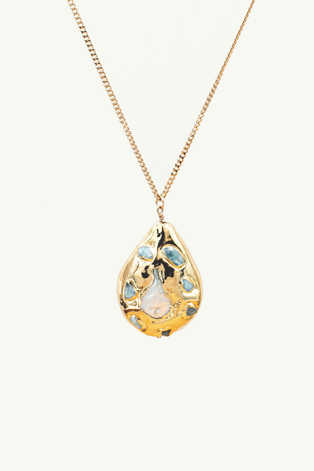 Gold pendant with a pearl in the center and aquamarines around the pearl.