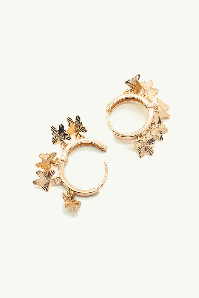 
                  
                    Gold hoops with butterflies 
                  
                