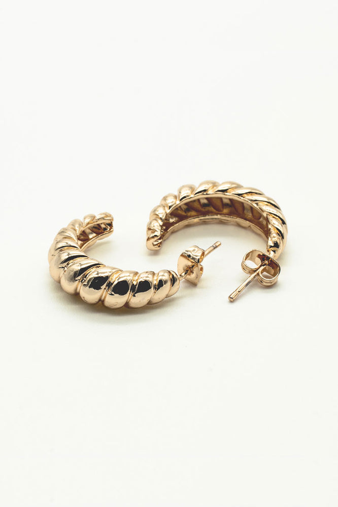 
                  
                    Croissant shaped gold hoops
                  
                