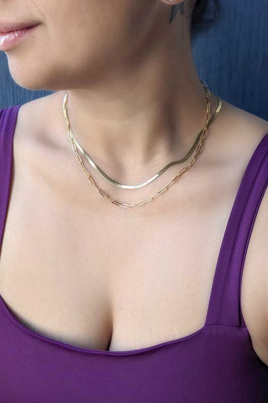 Load image into Gallery viewer, model wearing stacking chain necklaces 
