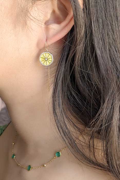 Model wearing Lemon threader earrings