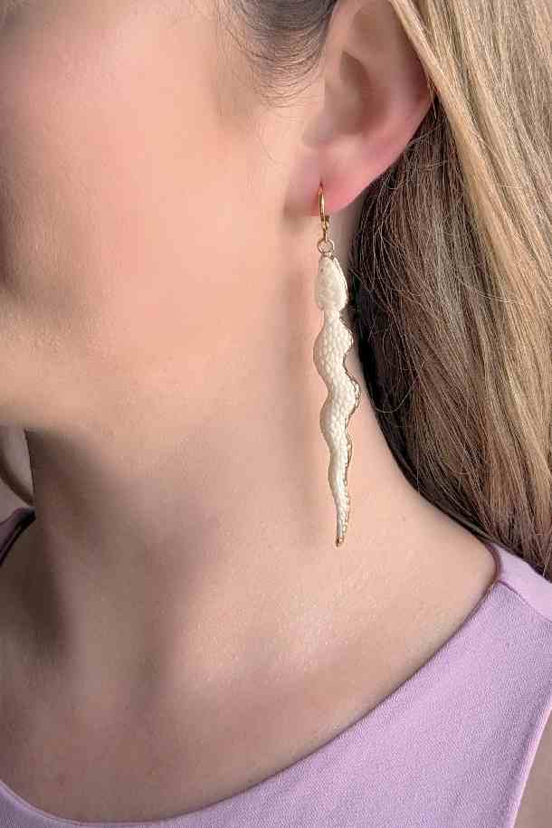 model wearing Laser carved bone snake earrings