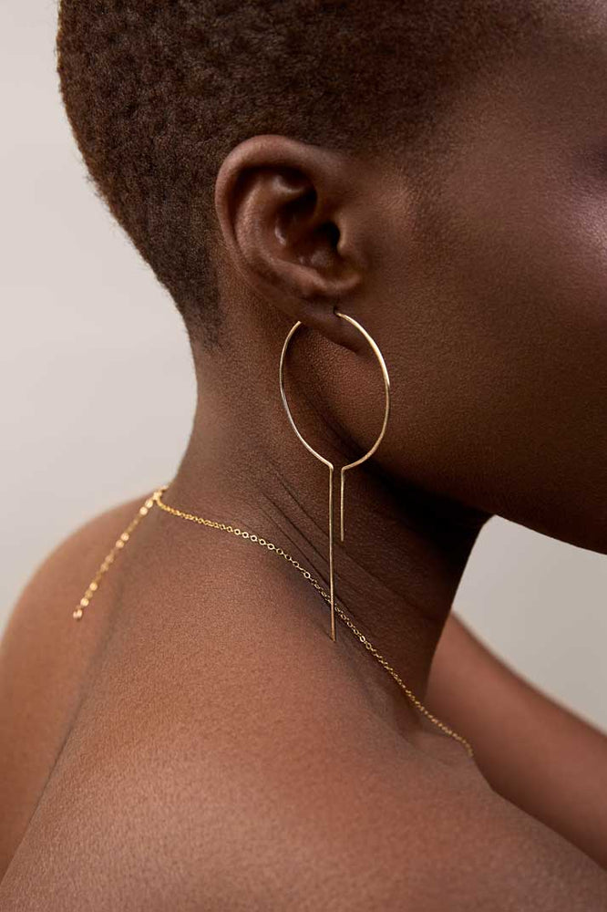
                  
                    Girl showing large size thread threader hoops
                  
                