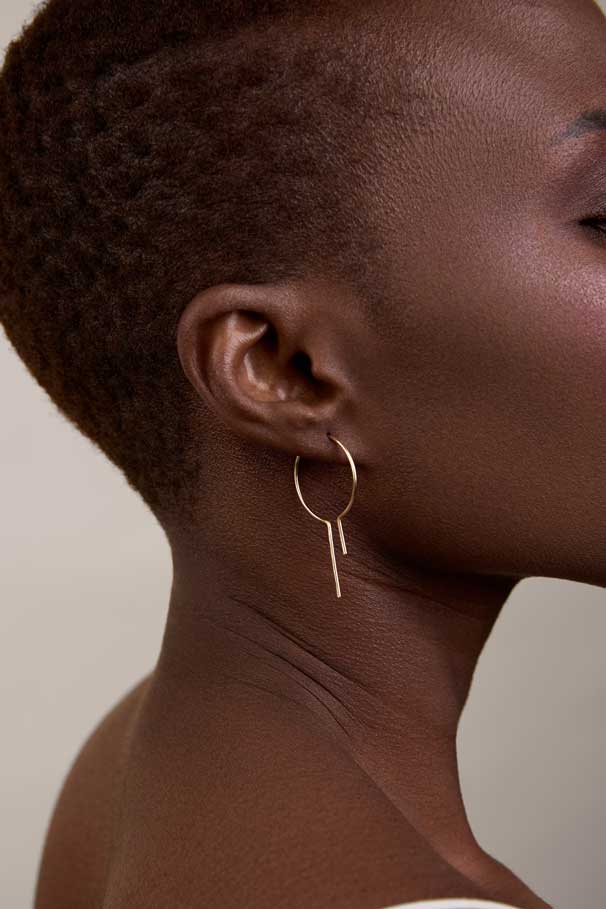 
                  
                    Girl showing small size threader hoops
                  
                
