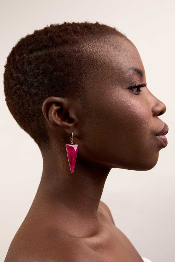 Girl wearing statement triangle ruby earrings