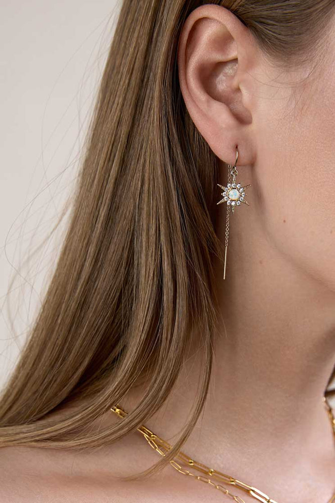 
                  
                    Long haired girl wearing gold opal sunburst threader
                  
                