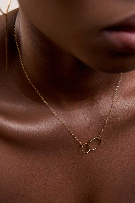 Neck showing dainty interlocked circles gold necklace