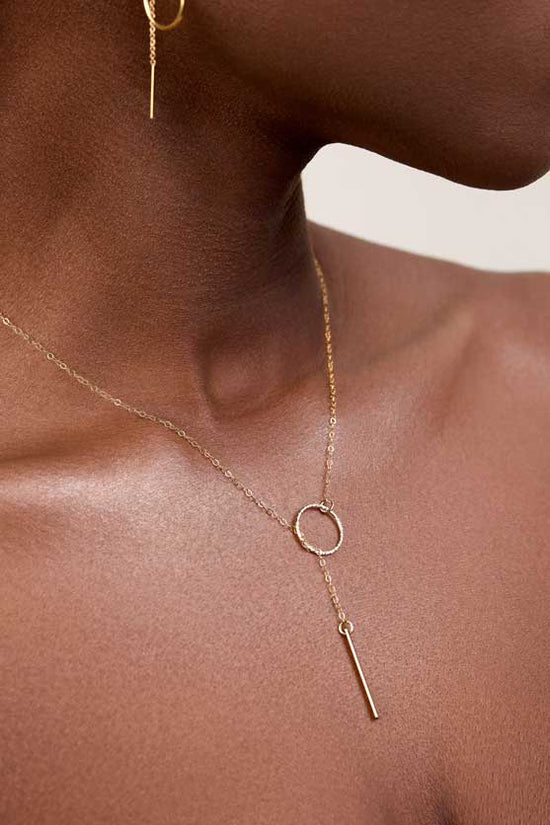 Model wearing a lariat necklace